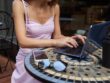 hands-young-girl-pink-dress-sitting-outdoor-table-working-with-laptop_115128-2119